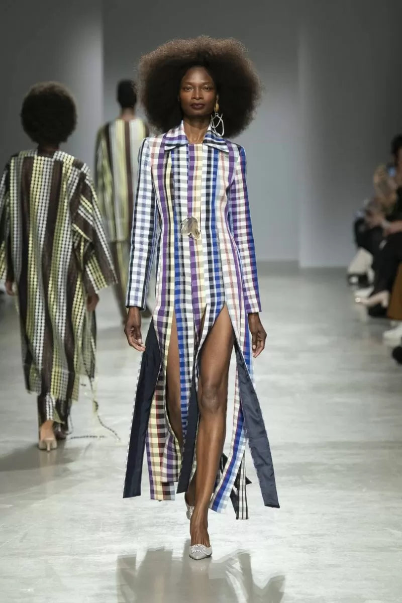 Model wearing checked Kenneth Ize dress on the runway