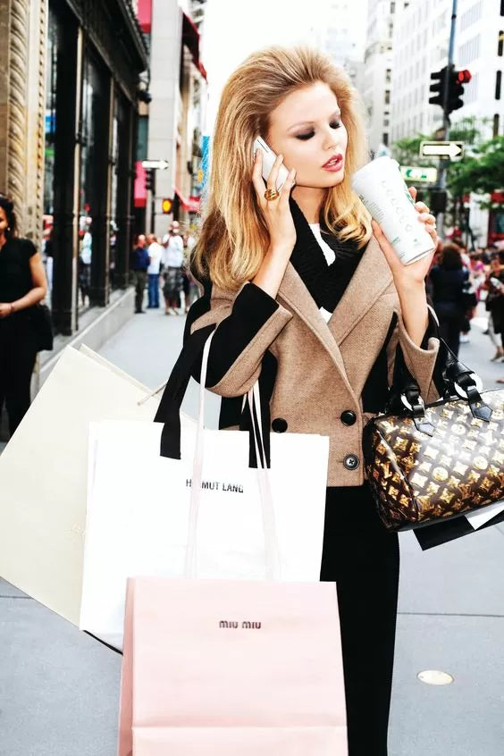 Glamorous model shopping with lots of bags