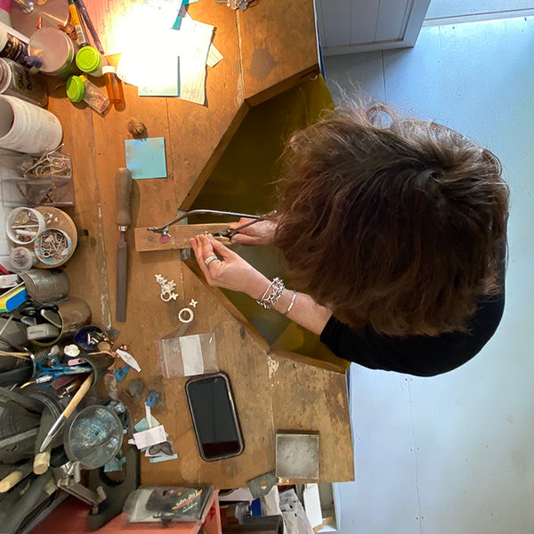 Jewellery Designer and Maker Sally Herbert working at a jewellery bench