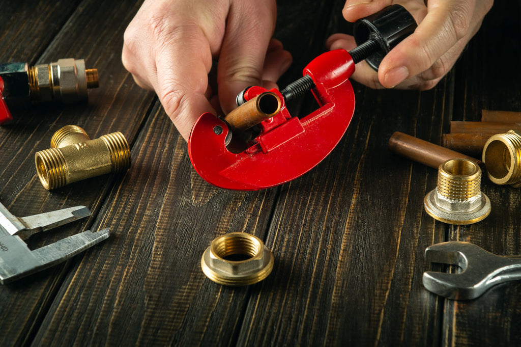 person using plumbing tools