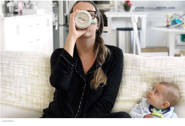 mom drinking coffee with baby on the couch