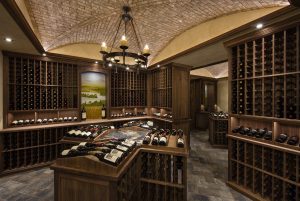 Mahogany finished wine cellar stacked with premium wine bottles.