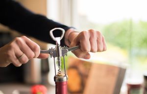  Unsealing a wine cork with a wine bottle opener