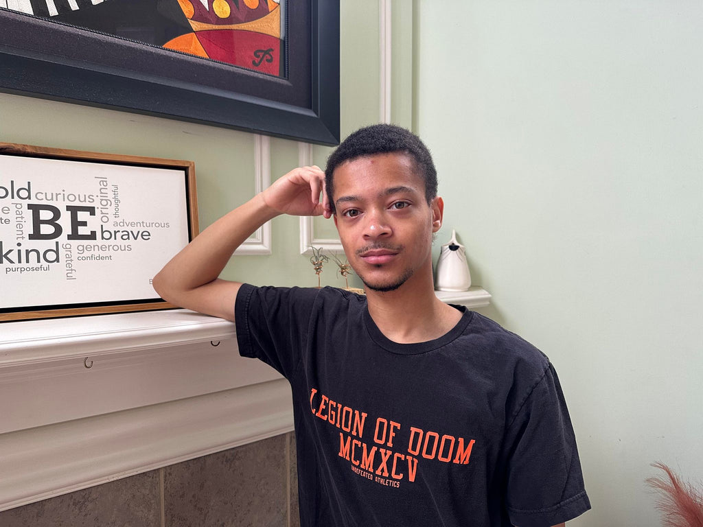 Image of Isaiah Montgomery standing next to fireplace