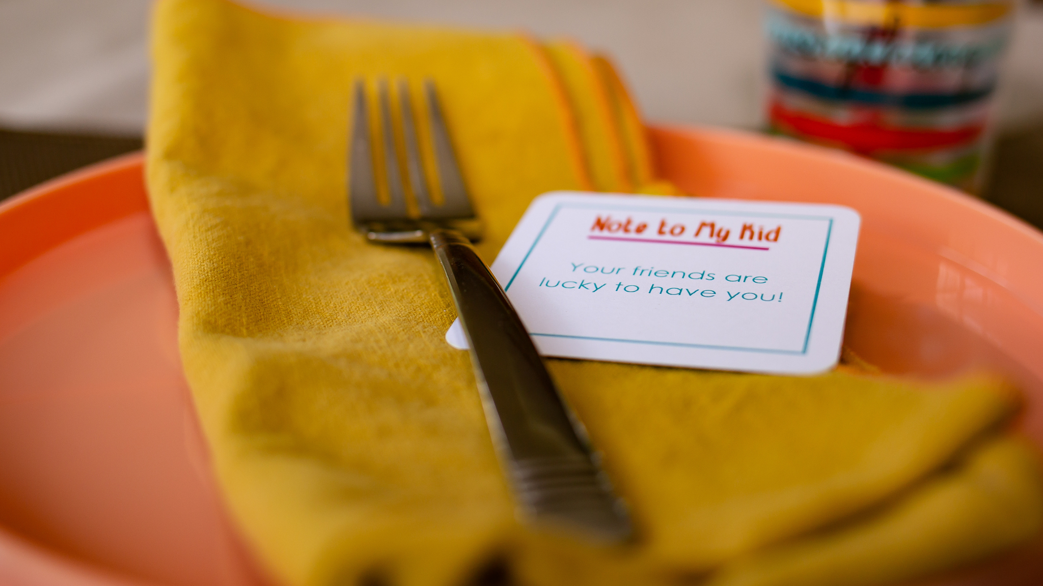 Note to My Kid Encouragement Card placed on top of a plate and napkin.