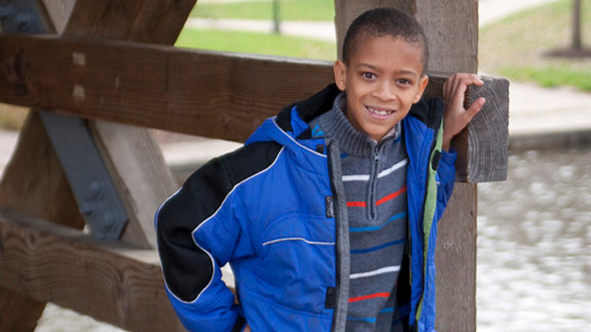 Isaiah outside in blue jacket