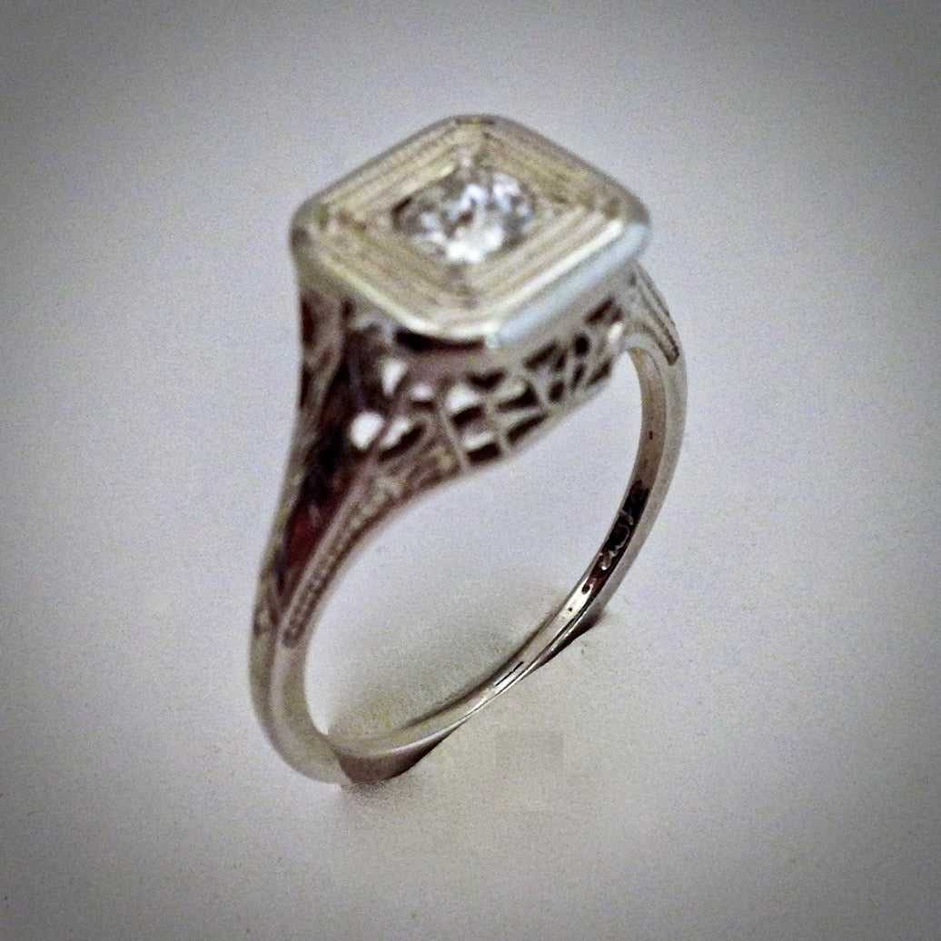 Ladies vintage 18KW filigree ring with a 1/4 carat diamond