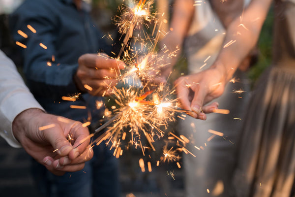 group of friends holding sparklers