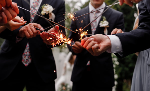 group of men holding sparklers