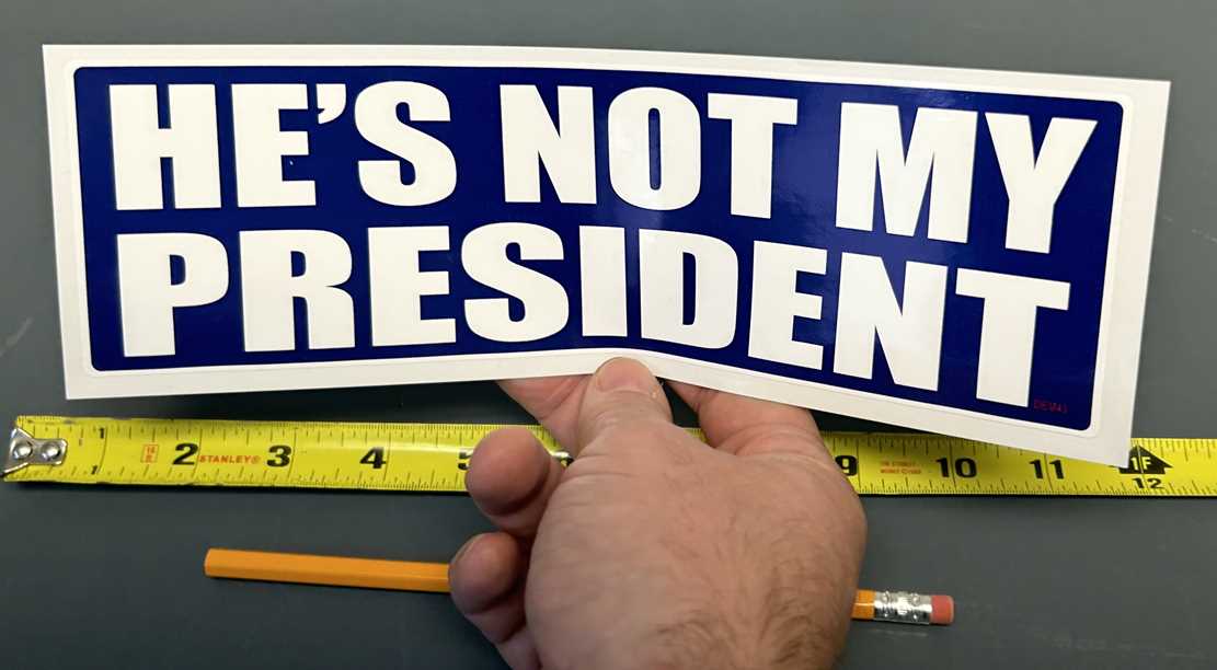 HE'S NOT MY PRESIDENT POLITICAL BUMPER STICKER IN HAND 