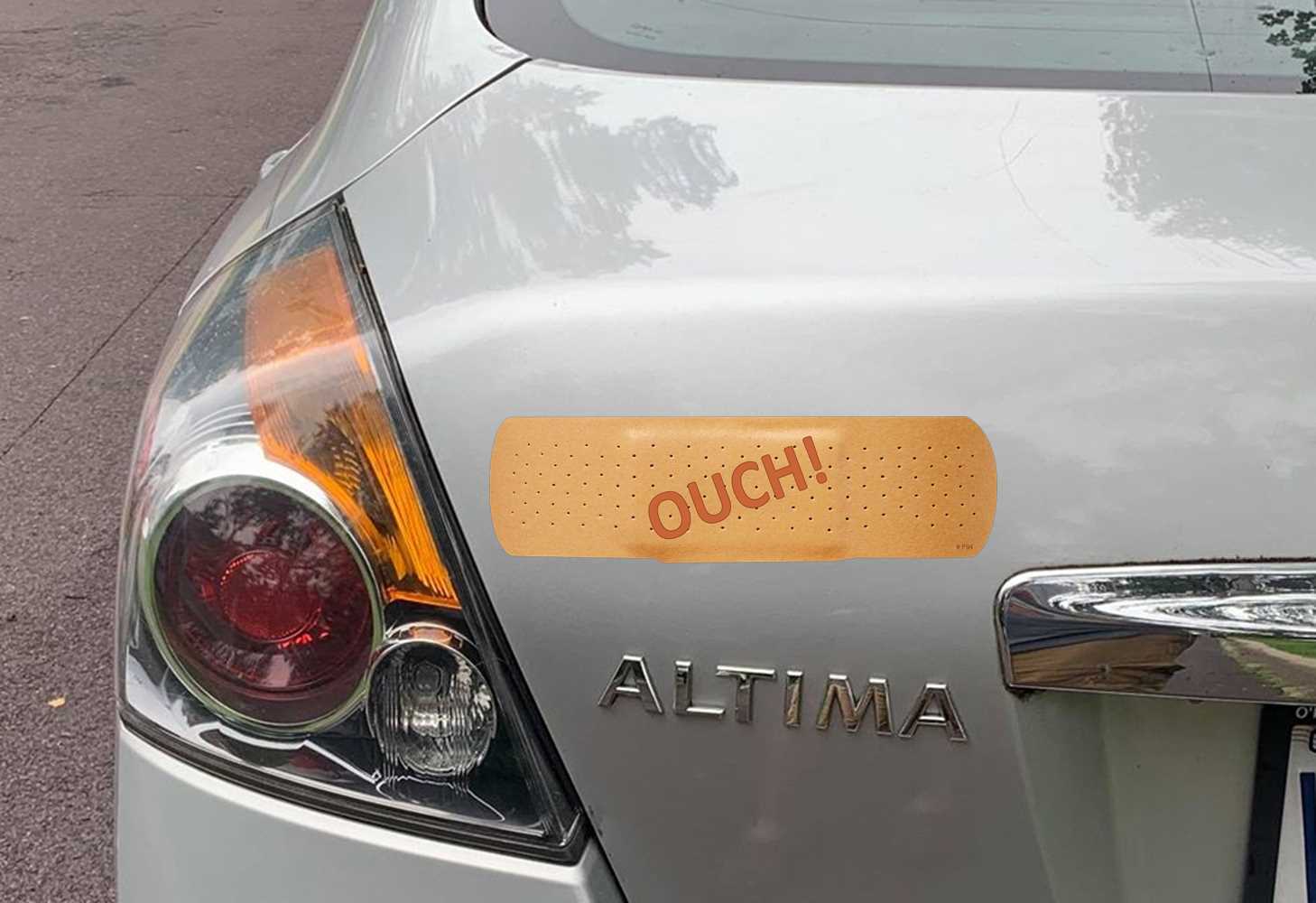 ouch band aid bumper sticker in hand