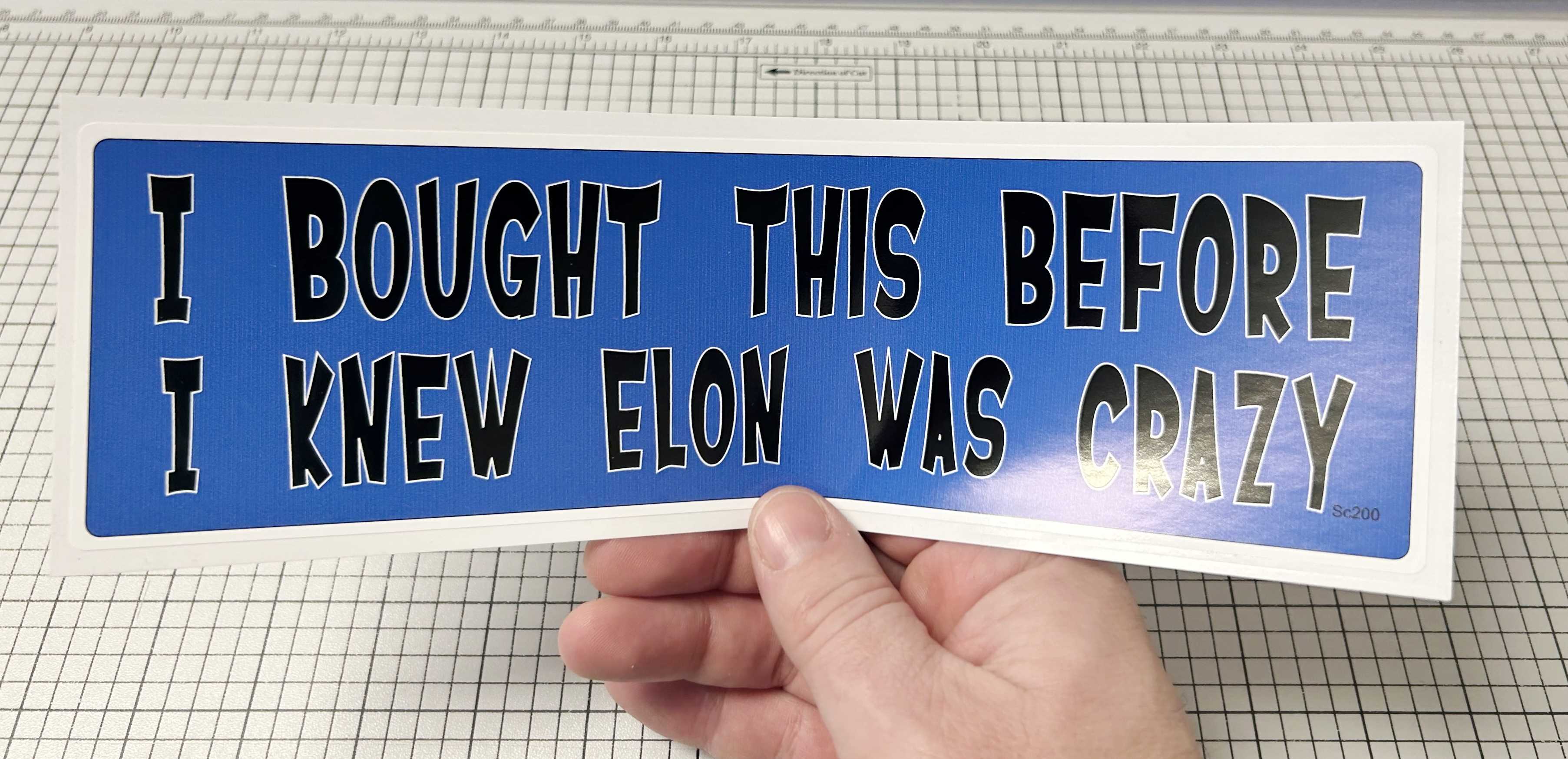I BOUGHT THIS BEFORE I KNEW ELON WAS CRAZY BUMPER STICKER IN HAND