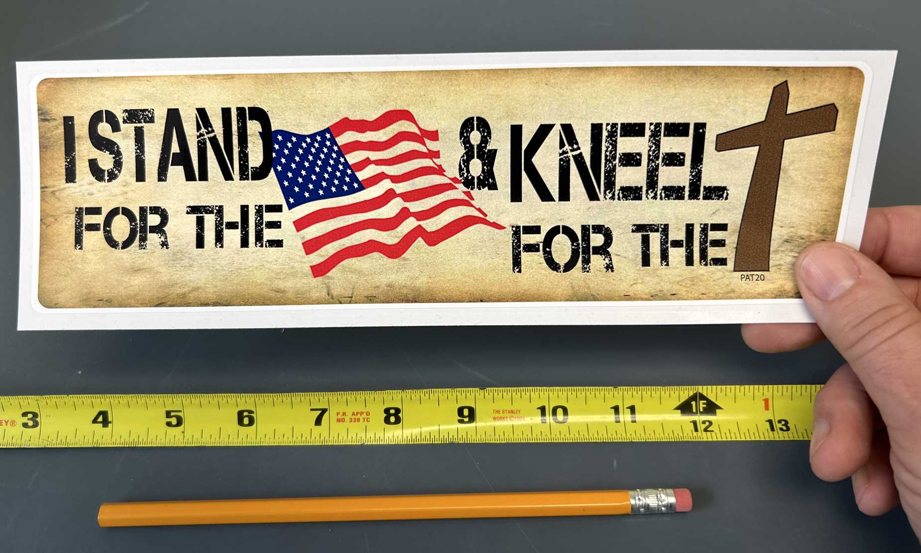 I STAND FOR THE FLAG AND KNEEL FOR THE CROSS BUMPER STICKER IN HAND