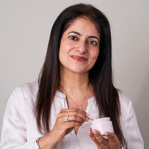 Anara Skincare’s founder Arati Nar holding a jar of Radiance Moisturiser.