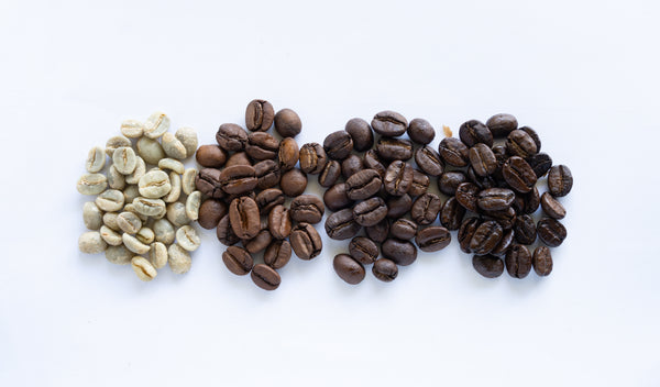 coffee beans with various roast types: green, light, medium and dark