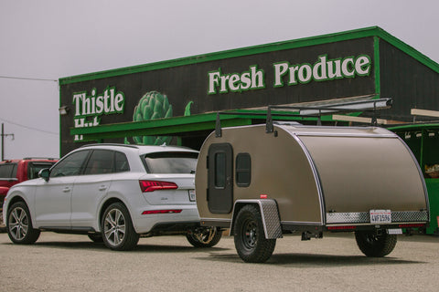 A Buffalo Teardrops camper in front of a produce stand in Moss Landing, CA 