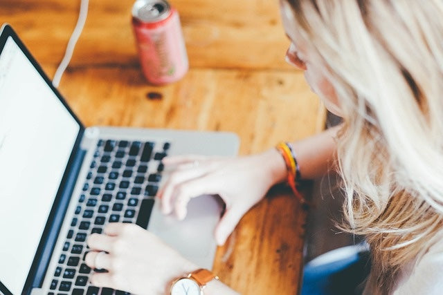 Woman working on Apple MacBook