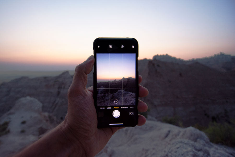 View of an iPhone taking a picture of a rocky sunset