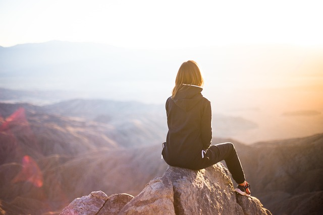 Woman overlooking mountains and sunrise