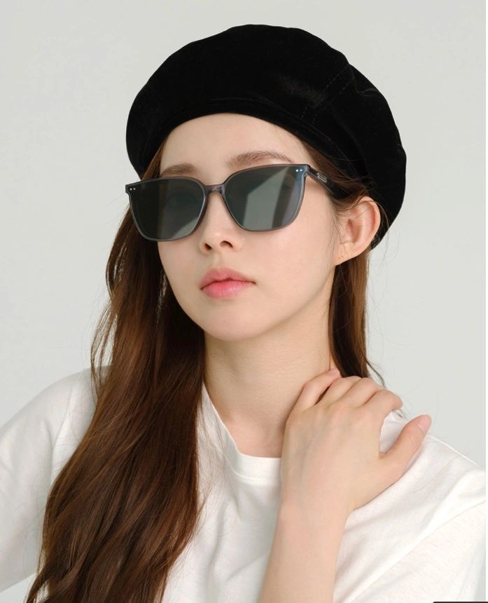 A chic and sophisticated lady, accessorizing her look with a stylish hat and fashionable sunglasses, embodying timeless elegance.