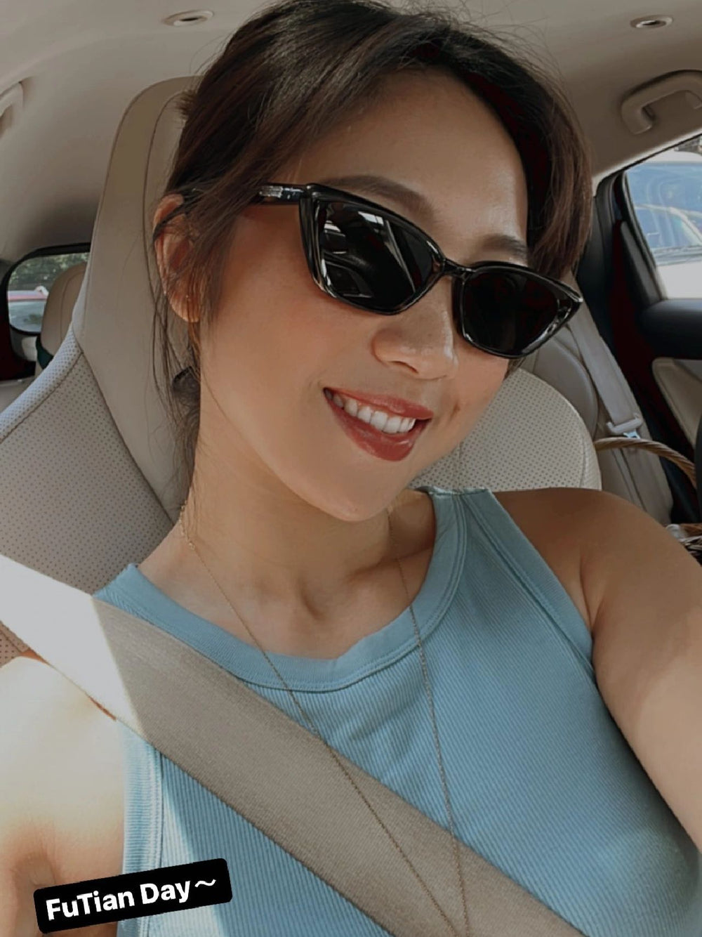 A stylish woman with mercury retrograde sunglasses relaxing in the back seat of a car.