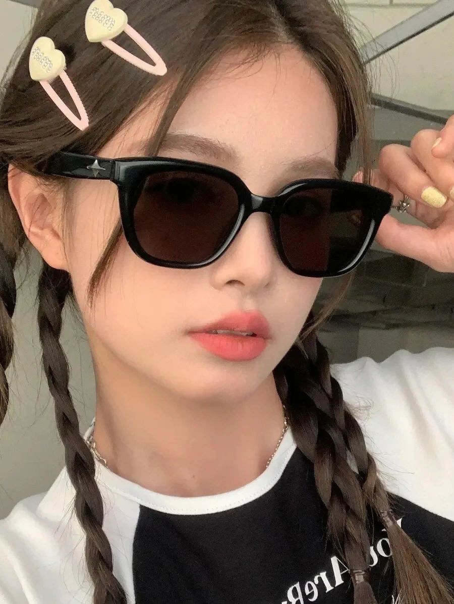 A chic girl with braids and Korean  fashionable sunglasses, radiating elegance and poise.