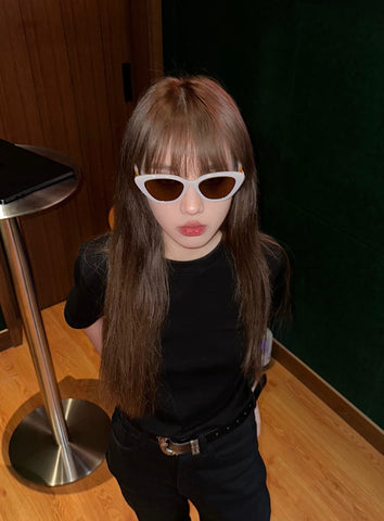 A girl wearing sunglasses and a black shirt, donning Virgo sunglasses from Mercury Retrograde