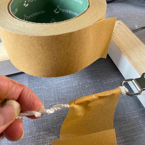 Wrapping packing tape around loose cord