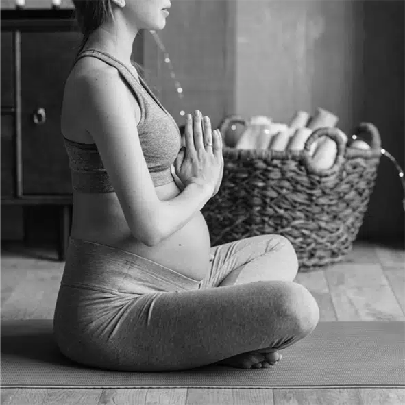 Pregnant woman in meditation pose on the ground. Image Pavel Danilyuk via Pexels