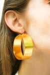 Shining gold-plated hoop earrings, exuding elegance and sophistication