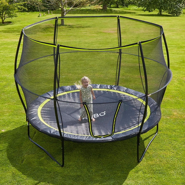 a child on a trampoline surrounded by a tall net
