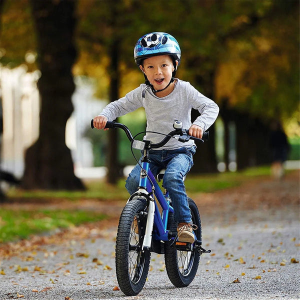 a child riding a blue bike in a park surrounded by leaves