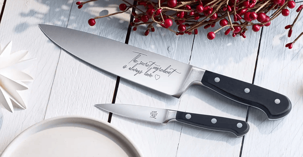 Two Engraved Kitchen knives on a table with personalisation