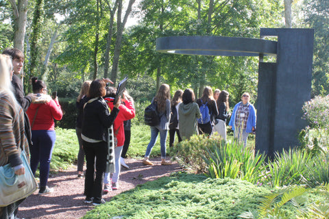 Docent Irene Tully fields questions from students about the mechanics of Takashi Soga's fantastic "Eye of the Ring" sculpture.