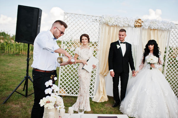 Best man pours champagne for newly married couple