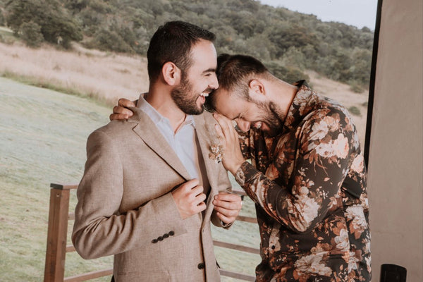 Groom laughs with his brother best man
