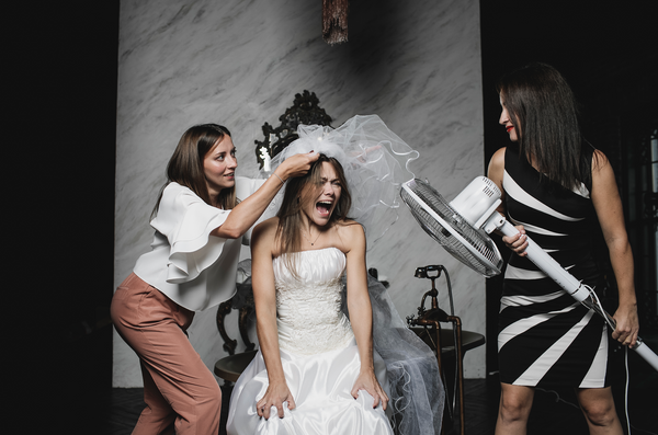 Funny bridesmaids laugh with bride before wedding reception