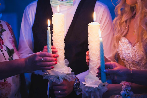 bride and groom light a candle together during creative wedding speech