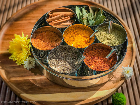 An array of BiBi Food’s Middle Eastern spices and herbs, featuring vibrant saffron, tangy sumac, aromatic za’atar, and rich cardamom, beautifully presented, enhancing natural culinary flavors