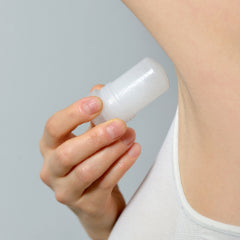 Woman applying a stick of deodorant