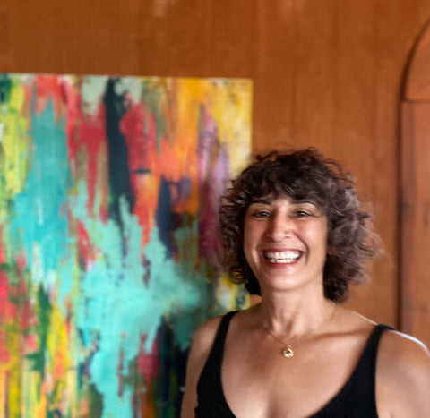 Artist Zeinab Ghais in front of one of her paintings