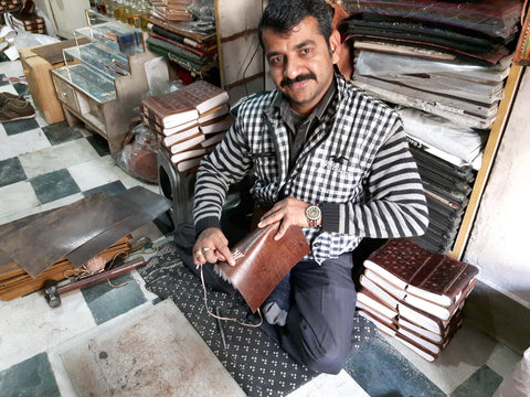 our leather journal maker showing us how he binds our journals