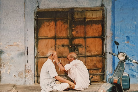two Indian men sitting cross legged