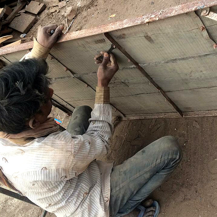 Securing the vintage table top back into place on the iron frame 