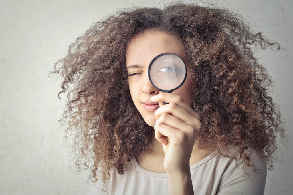 Latina Woman Looking at Magnifying Glass at Penis Pump Man with Enlarged Member