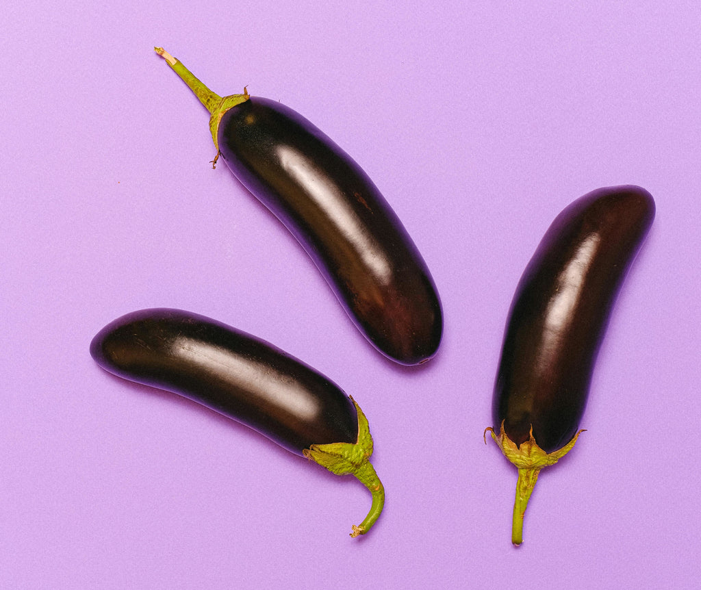 3 Eggplants on Purple Background