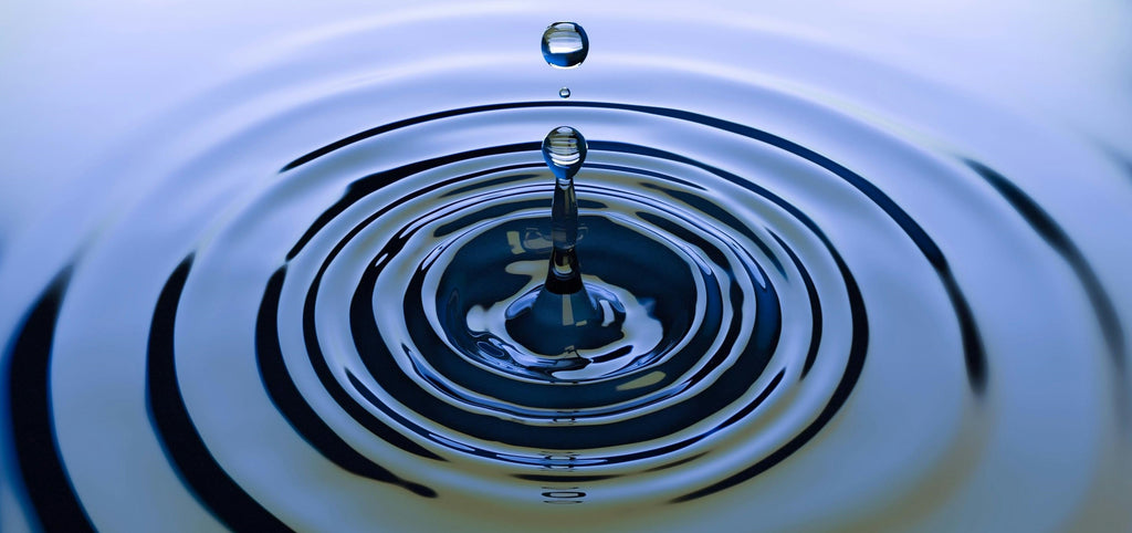 Droplet of water in a puddle