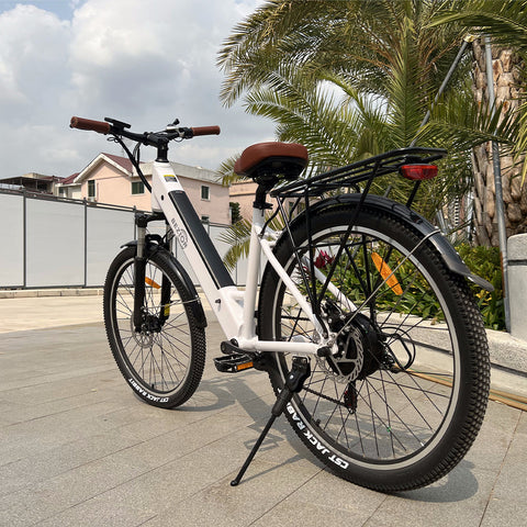 White e-bike parked outside in an urban environment, highlighting the accessibility of electric bicycles in the Benelux.