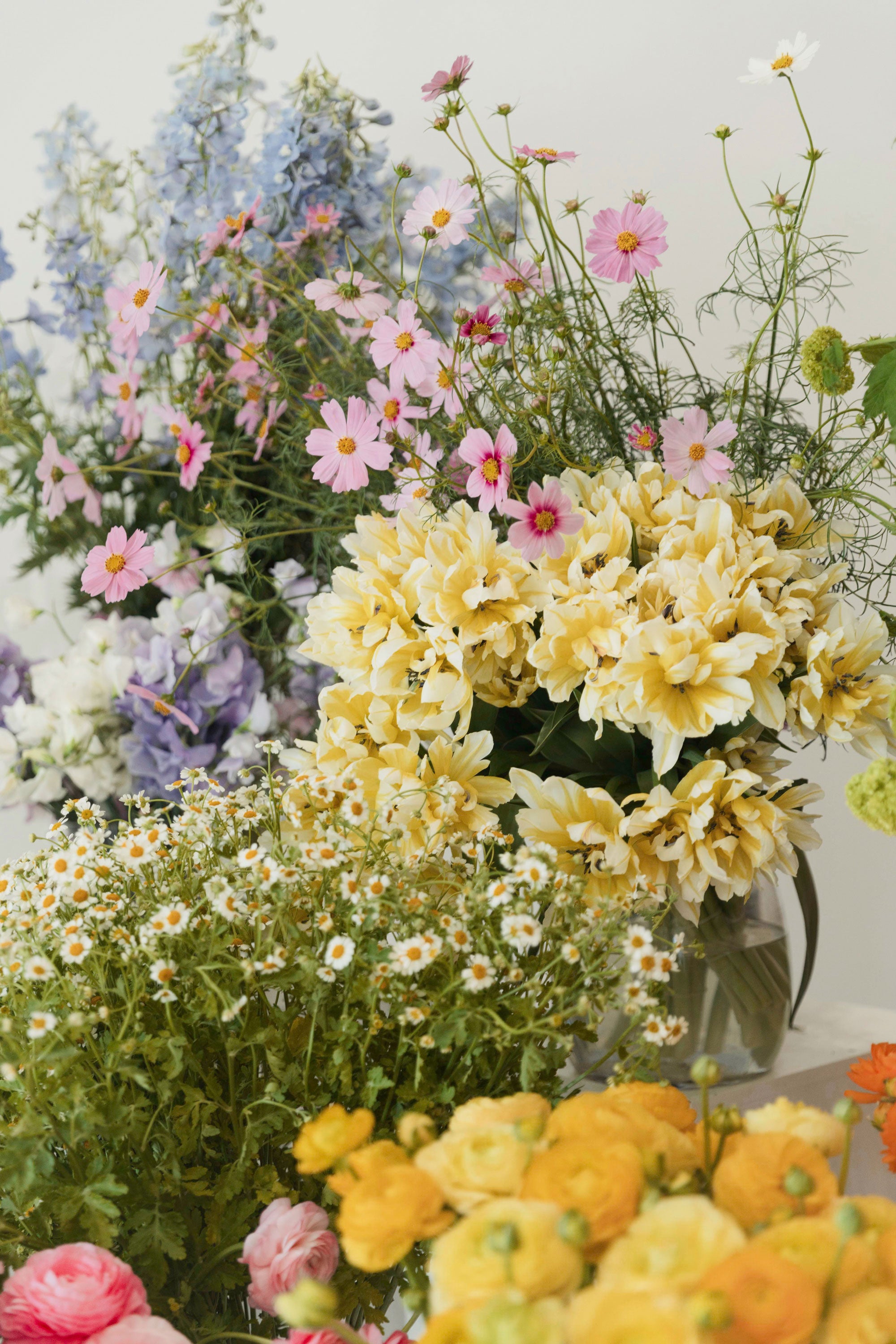 collage of a colourful table arrangement at a wedding with blue orchids and pink roses