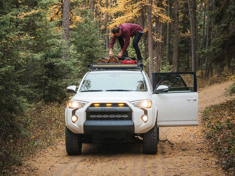 Driver checking Toyota 4Runner roof rack load.